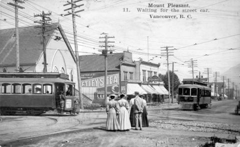 1908. group of people in the middle of Main St. (then Westminster Ave.). Two streetcars approaching.
